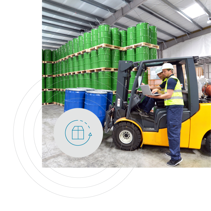 Full shot of a warehouse with a yellow forklift operated by two people, surrounded by stacked drums, with a graphic icon representing inventory flow.