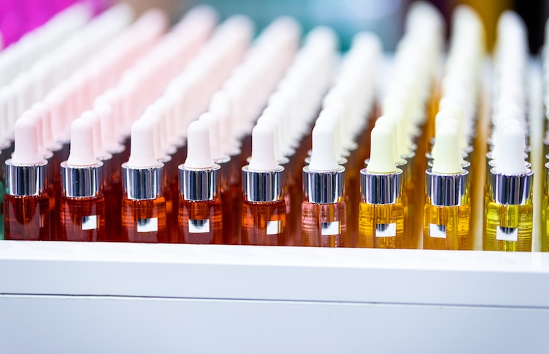 Set of cosmetic bottles in rows, equipment for beauty store