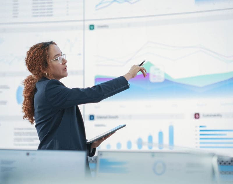 woman at screen with graphs
