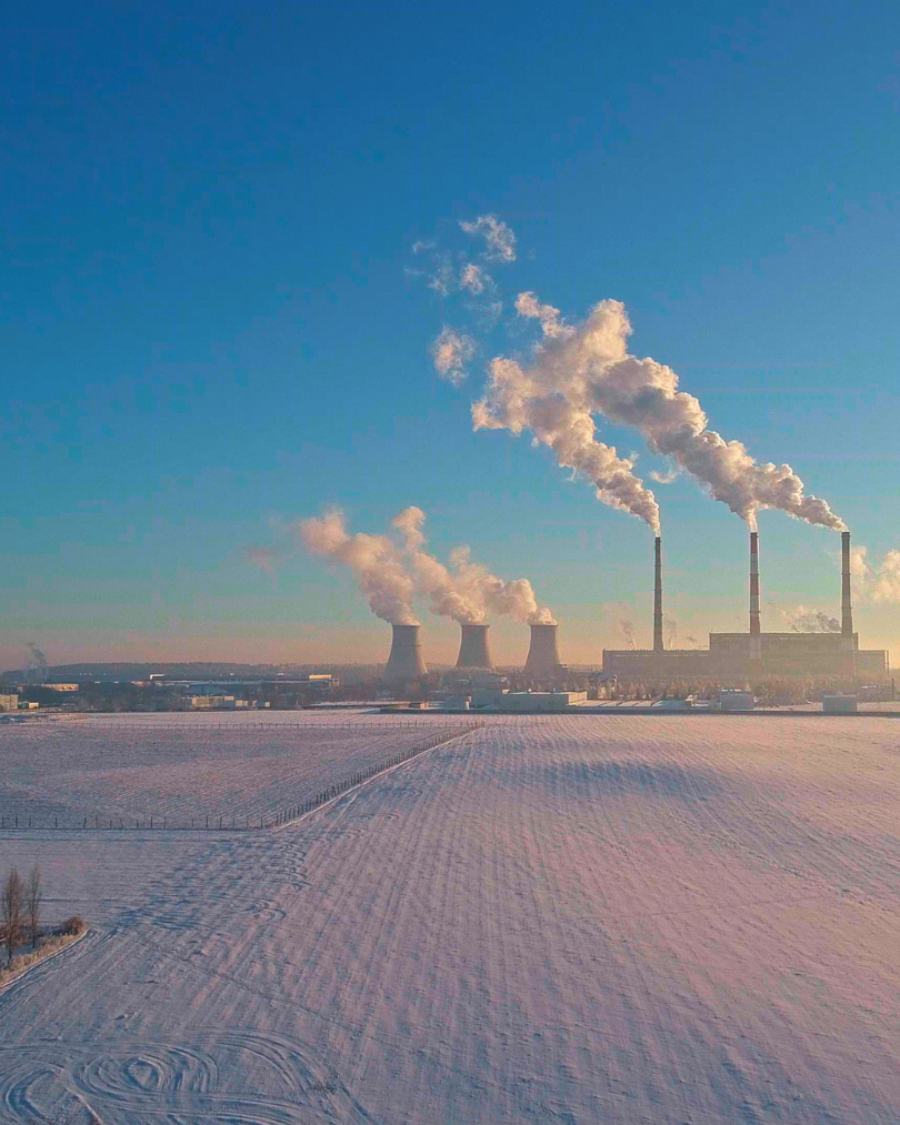 Industrial smokestacks in the distance