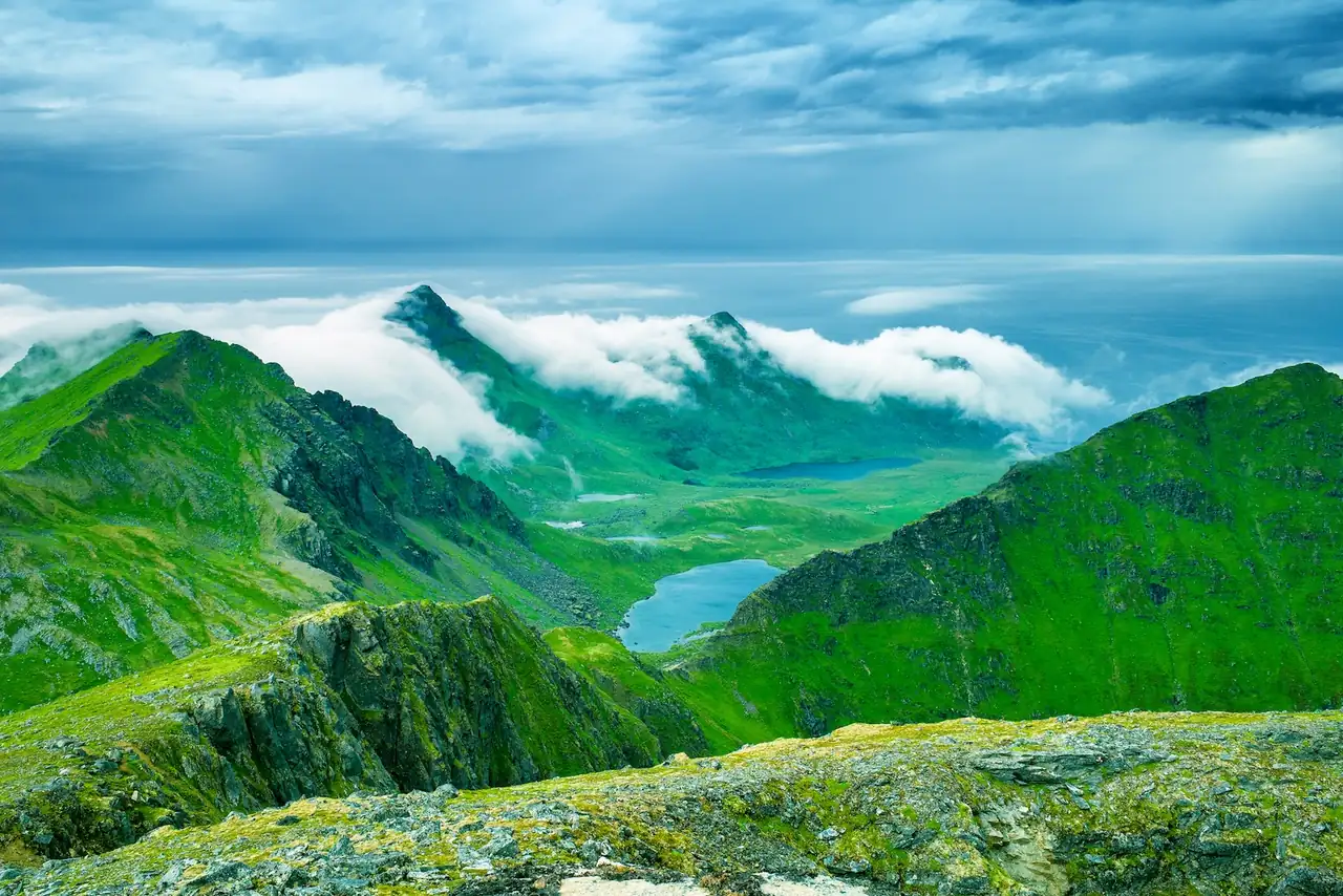 view of mountain range with clouds