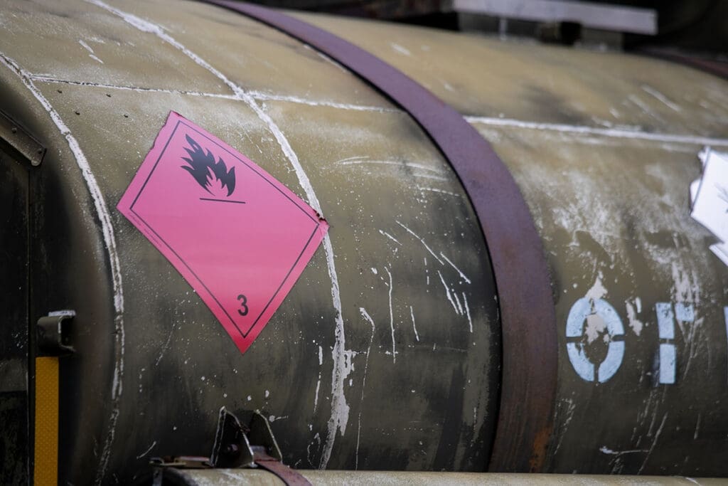 An LPG tank secured with a strong chain and showing a Flammable Gas