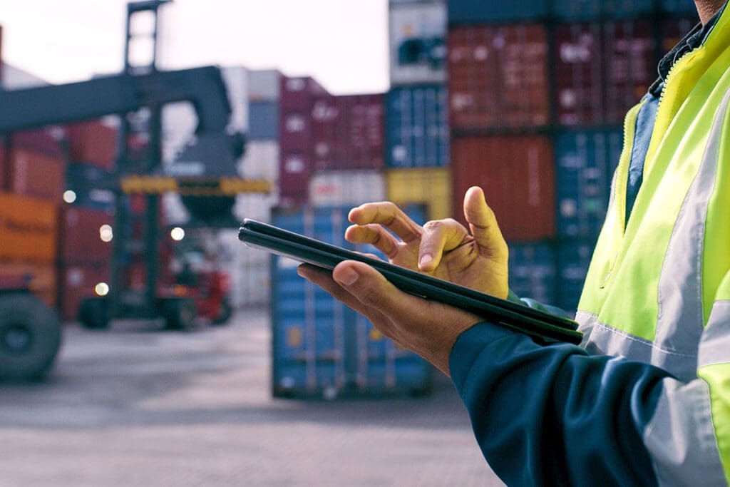 Hand, worker and tablet for shipping outdoor for cargo crane, inventory inspection and delivery safety of logistics. Person, digital and container information, transport service and distribution site