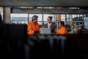 Team members meeting over an open laptop