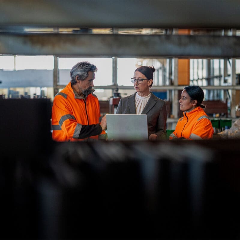 Team members meeting over an open laptop